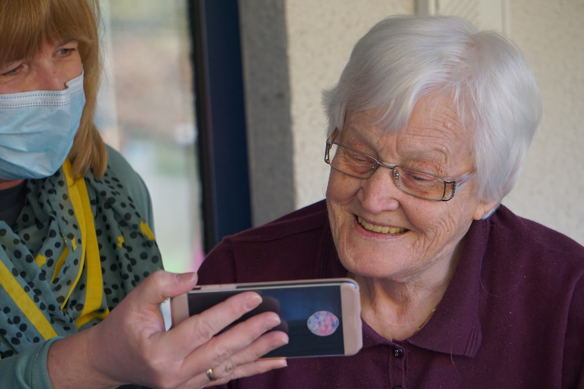 Care worker checking patient information on a phone