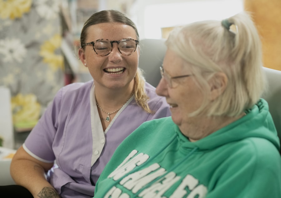 Two elderly women laughing together indoors at home